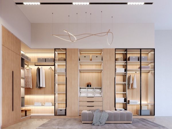 Dressing room with glass-front wardrobes and an ottoman