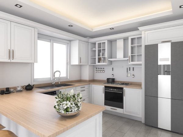 White traditional kitchen with a wood-topped island and glass display cabinets
